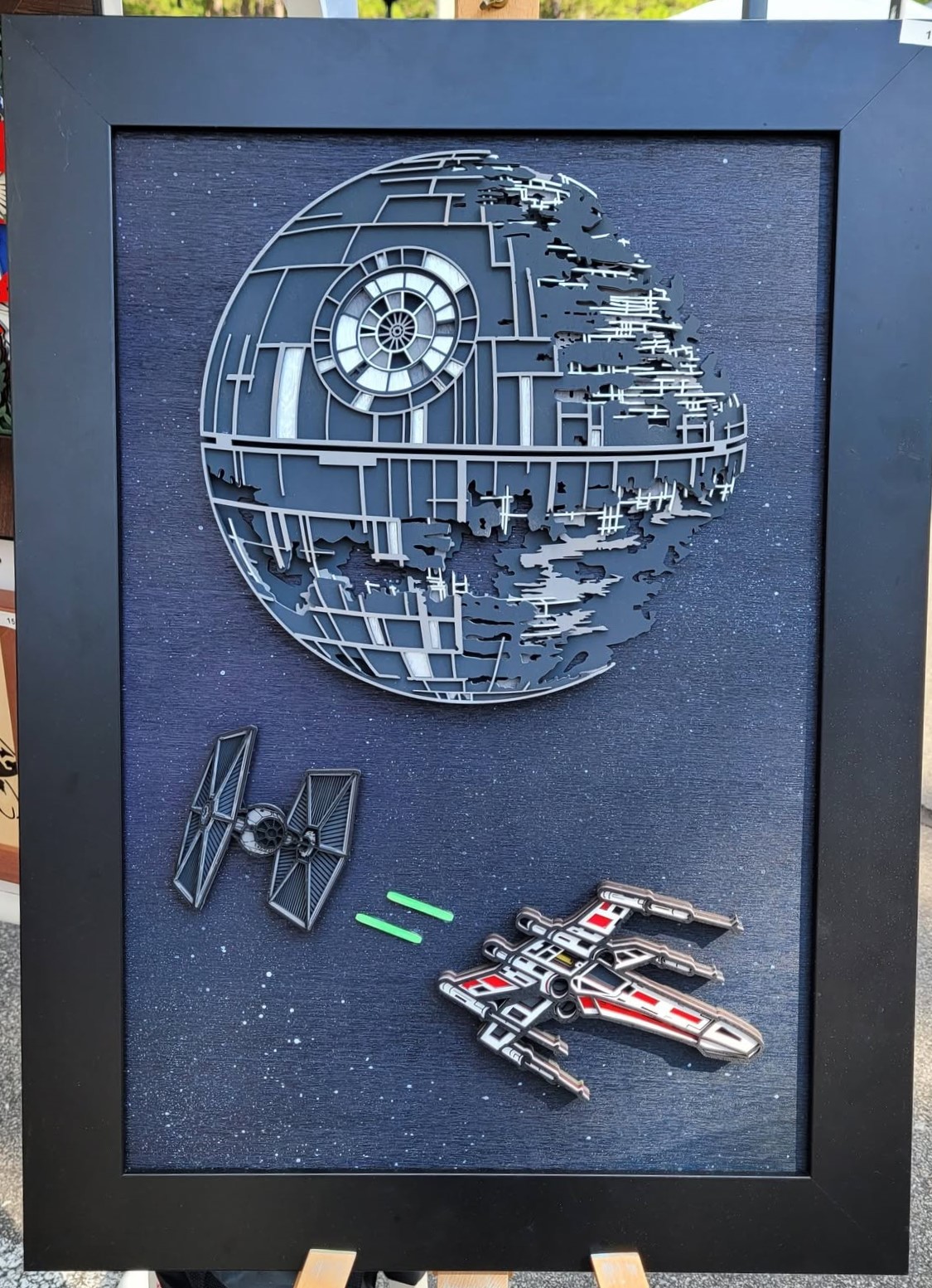 Layered wood art of a Death Star, X-Wing and Tie Fighter from Star Wars